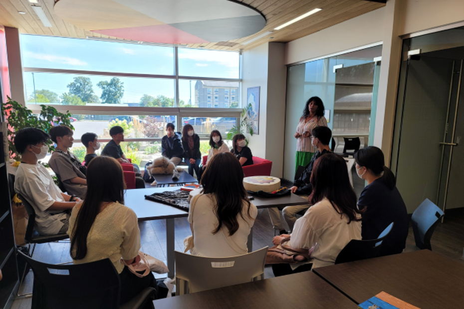 Students from Nagoya University gather in the Indigenous Centre at SLC to listen to Knowledge Keeper Helena Neveu.